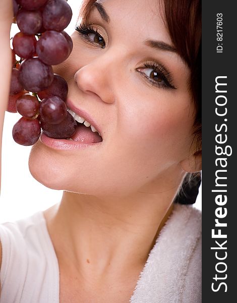 Attractive woman with grapes. over white background
