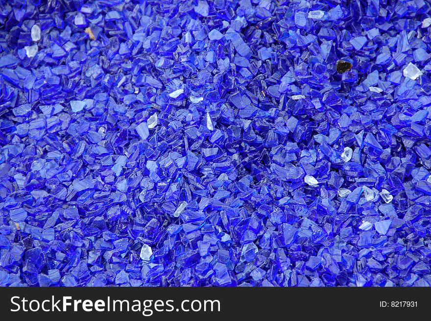 Decorative bright blue glass pieces closeup background. Decorative bright blue glass pieces closeup background