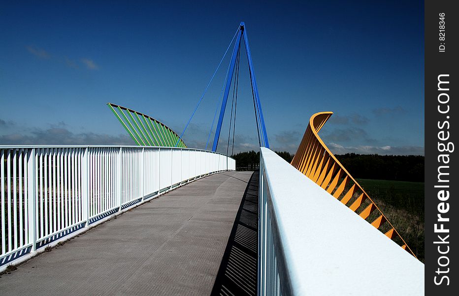 A wide angle image looking across the span of the  national cycle network bridge spanning the A689 road. A wide angle image looking across the span of the  national cycle network bridge spanning the A689 road