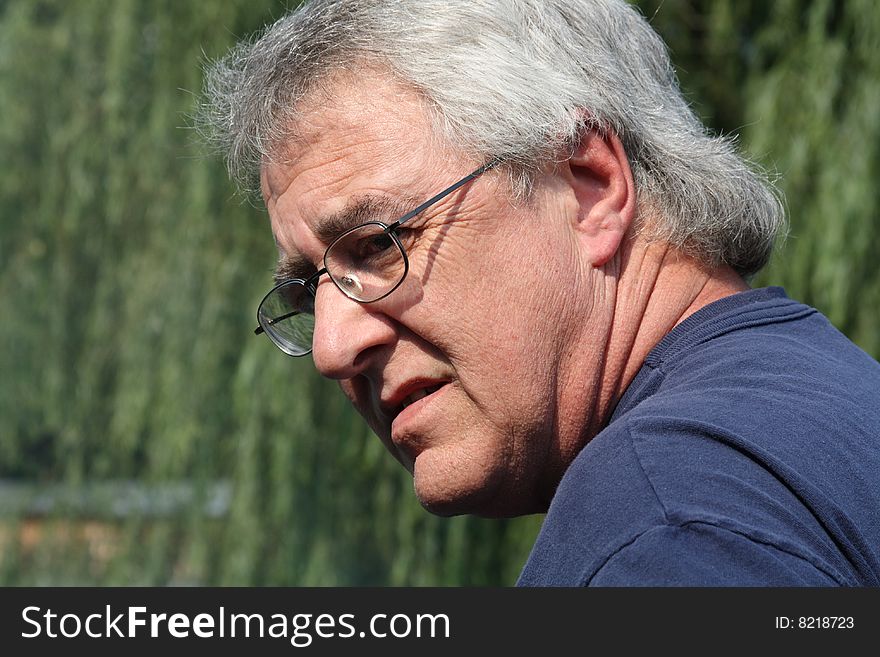 Baby boomer man smiling with gray hair and glasses