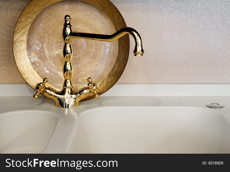 The beautiful water faucet of gold color