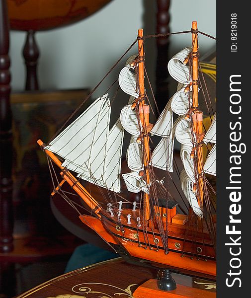 Model sailing ship is on the table