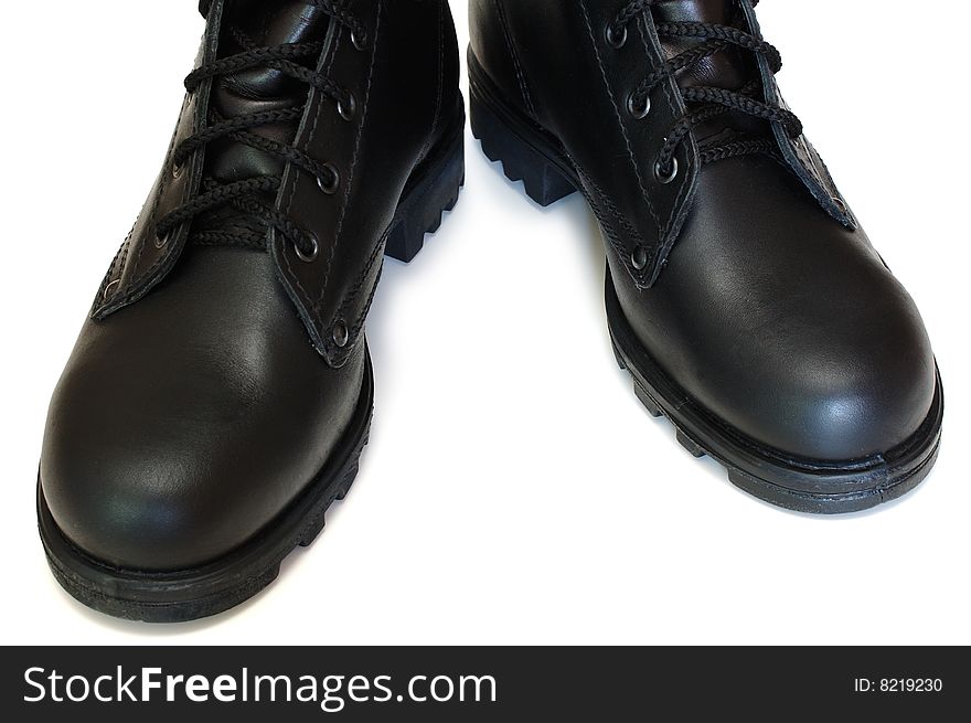 Two black leather army boots on isolated (white) background. Two black leather army boots on isolated (white) background.