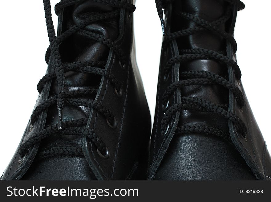 Two black leather army boots on isolated (white) background. Two black leather army boots on isolated (white) background.