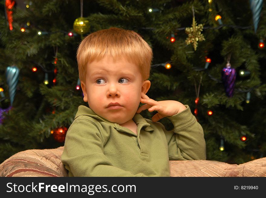 A two-and-a-half year old boy patiently awaits his portrait to be photographed. A two-and-a-half year old boy patiently awaits his portrait to be photographed.