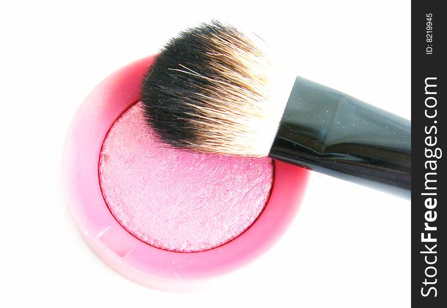 Pink blush with a brush on a white background