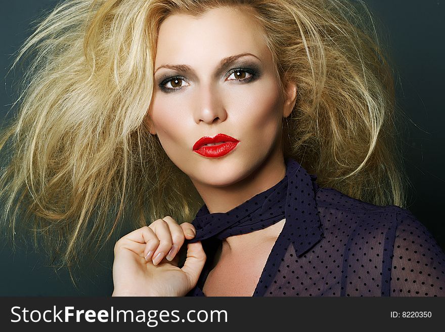 Fashion portrait of a blonde with red lipstick. Beauty