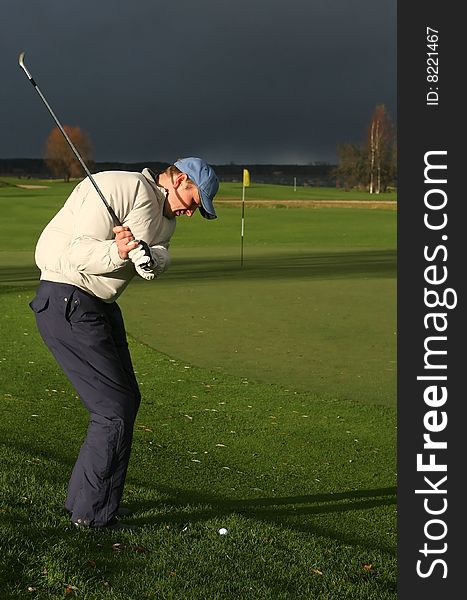 A golf player strikes a tee shot