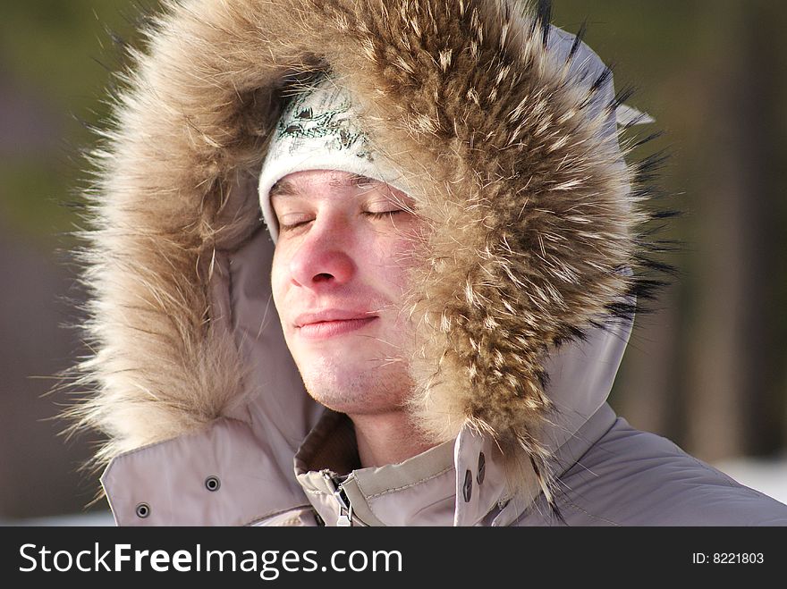 The young man enjoys winter air. The young man enjoys winter air