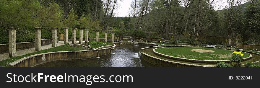 A beautiful garden with waterfalls, stone pathways, and short cut green grass. A beautiful garden with waterfalls, stone pathways, and short cut green grass.