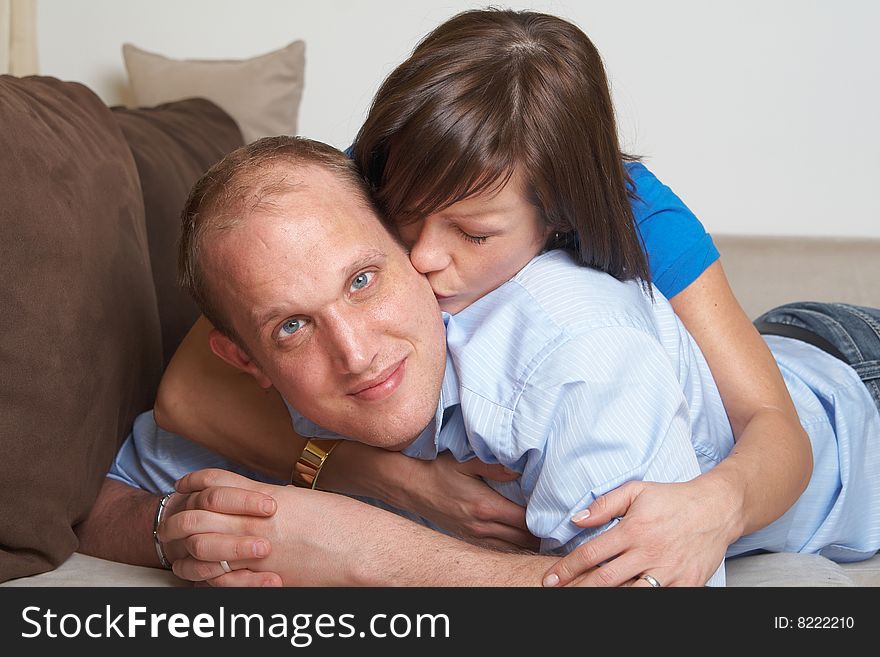 Beautiful young couple on a couch in their new appartment. Beautiful young couple on a couch in their new appartment.