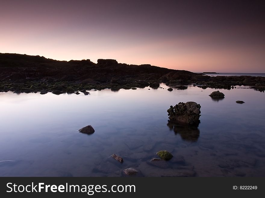 Beautiful ocean cove taken in Anna Bay, NSW, Australia during twilight conditions.