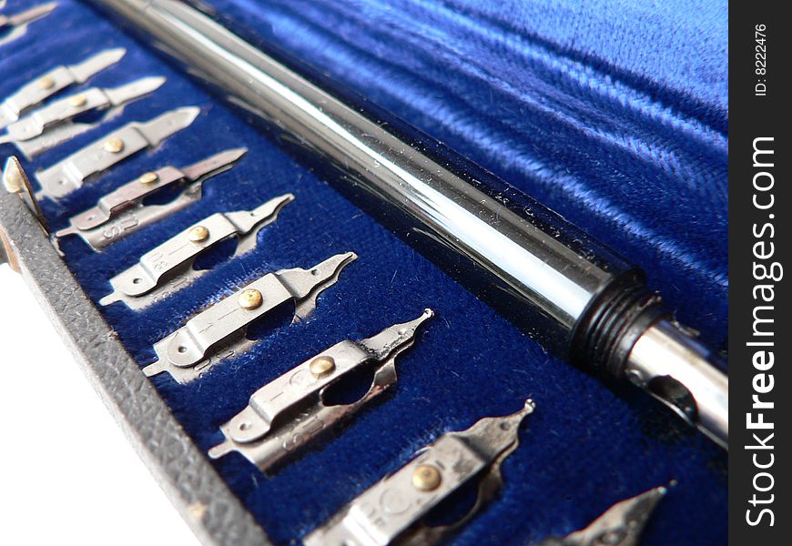 A unique set of antique engineering / inking instruments from approximately 1910. They are shown in their blue velvet case. Isolated on white background. A unique set of antique engineering / inking instruments from approximately 1910. They are shown in their blue velvet case. Isolated on white background.