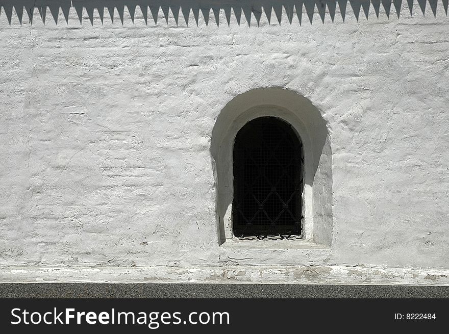 A window in a monastery wall. A window in a monastery wall