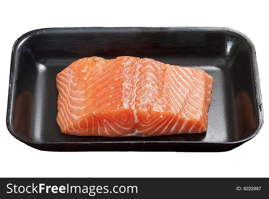 Raw salmon fillet on black container isolated on white background