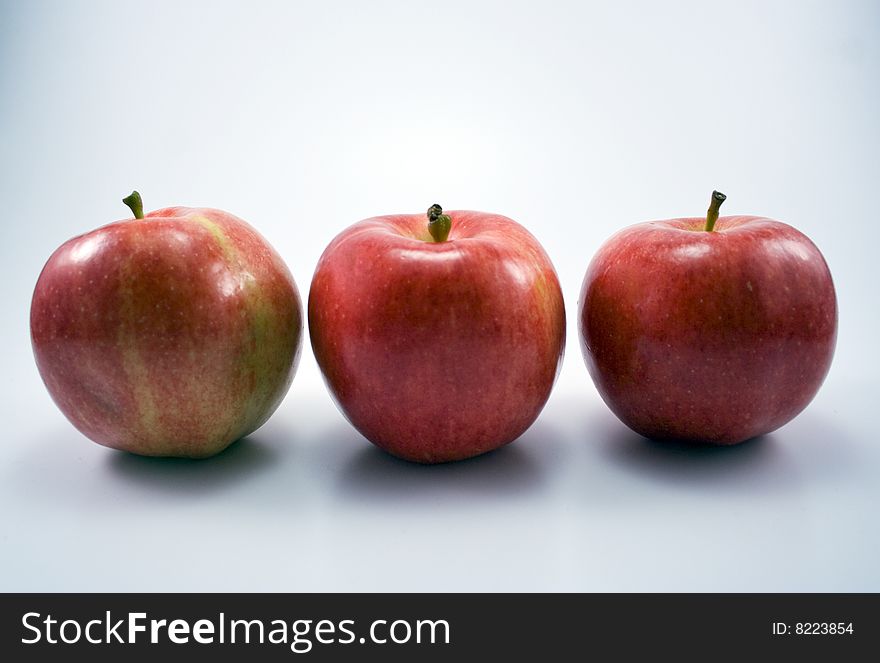 An image of three apples in a row.