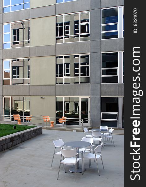 A modern loft courtyard with tables and chairs