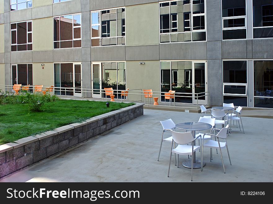 A modern loft courtyard with tables and chairs