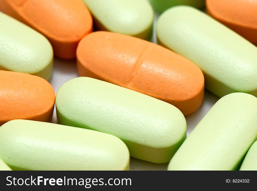 Green and orange pills background. Green and orange pills background
