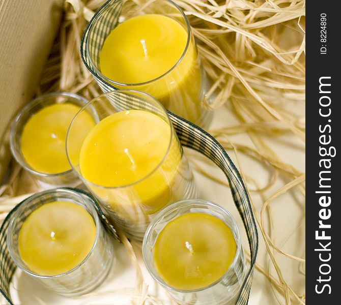 Yellow candles, ribbon and box closeup