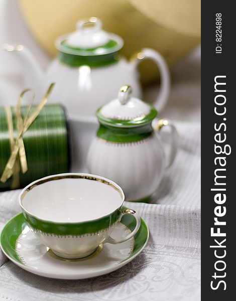 White with green tea service and gift box on napkin