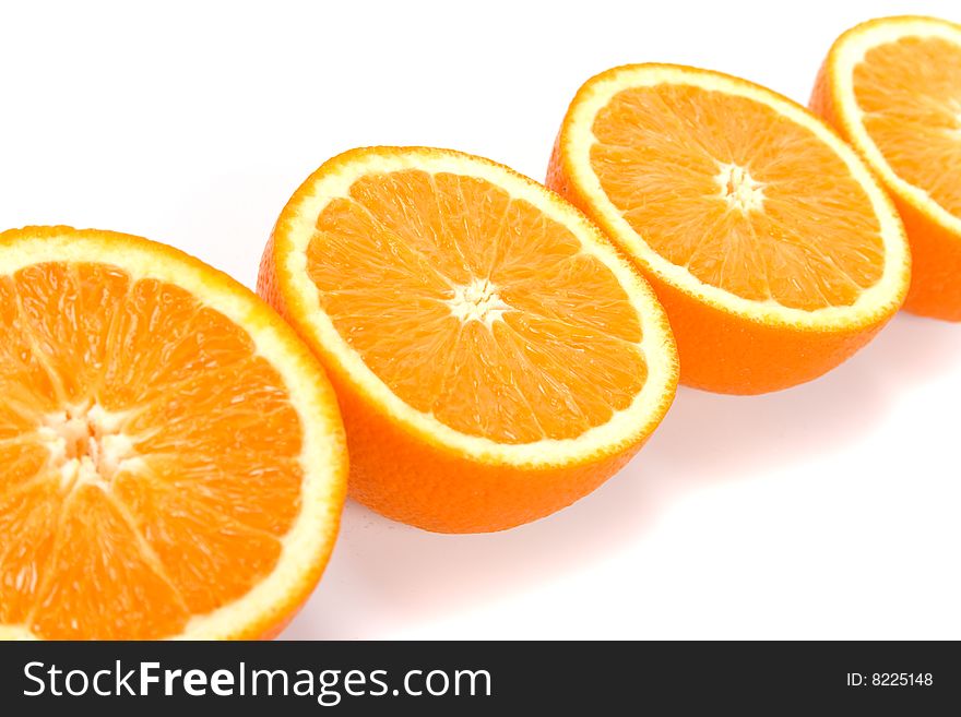 Fresh oranges halves closeup on white