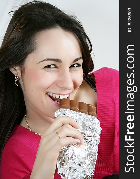 Beautiful young  woman eating a chocolate