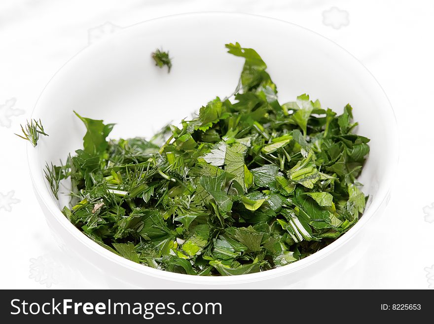 Green tops of parsley on white background