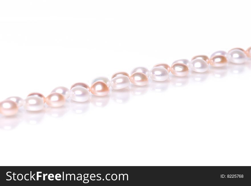 Beads of pearl on the white background