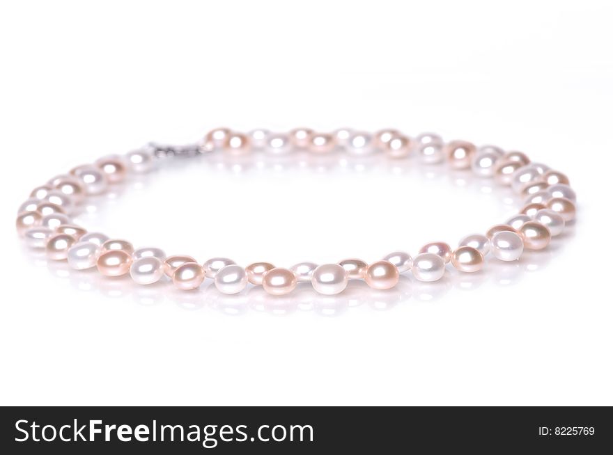 Beads of pearl on the white background