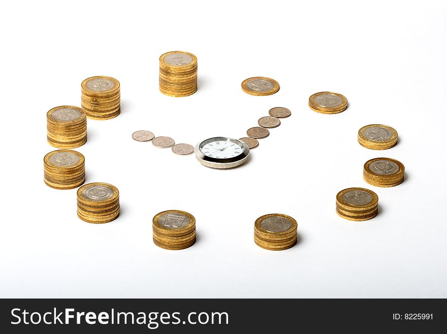 Coins in the shape of a clock with a watch in the middle on white background. Coins in the shape of a clock with a watch in the middle on white background