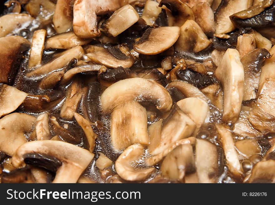 Slices of mushrooms roasting in pan. Slices of mushrooms roasting in pan