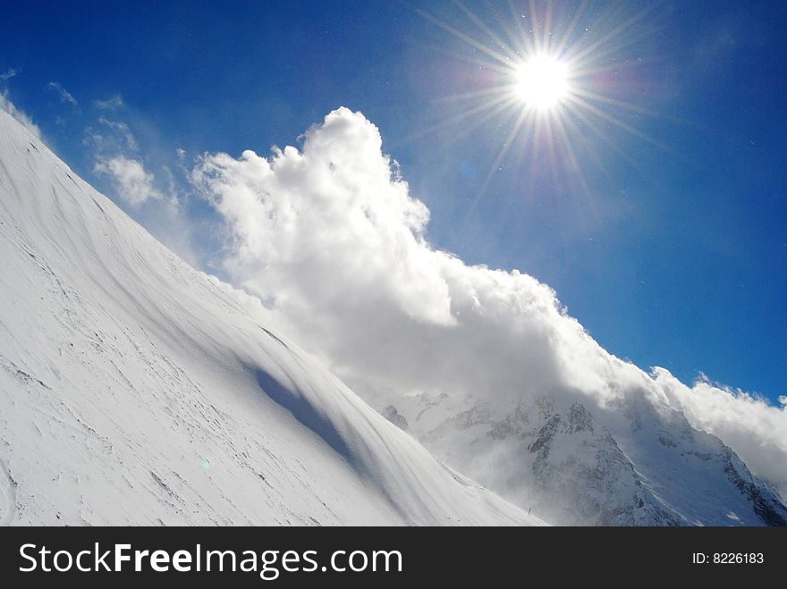 Beautiful view of winter mountain and shining sun. Beautiful view of winter mountain and shining sun