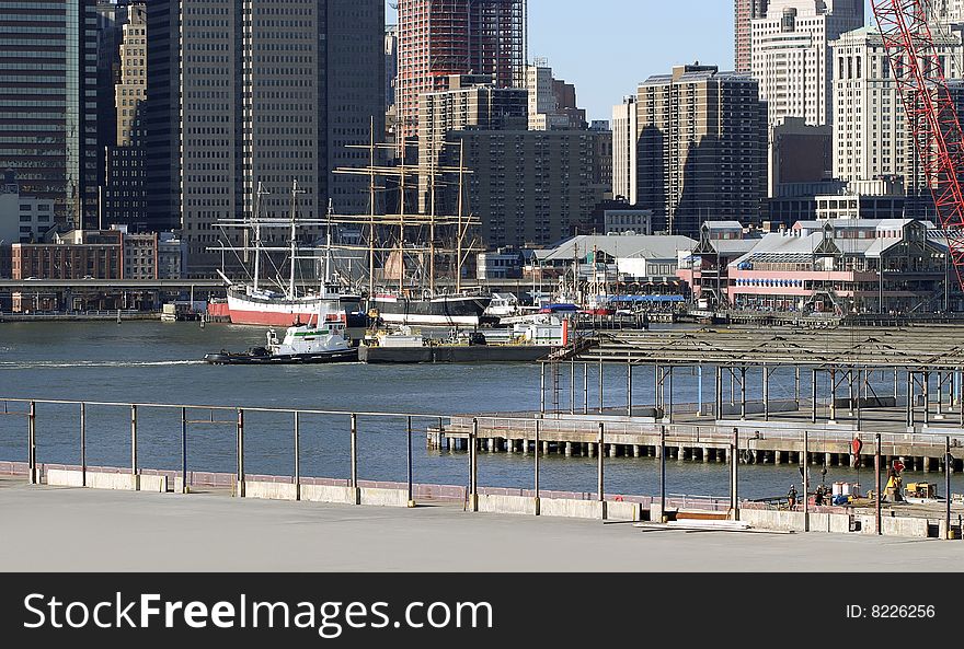 Shot from Brooklyn promenade of ferry pushing a barge. Shot from Brooklyn promenade of ferry pushing a barge