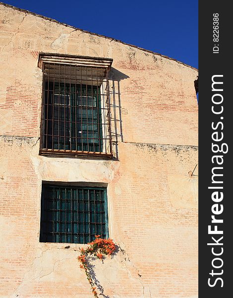 Barred factory windows in the village of Frigiliana in Spain. Barred factory windows in the village of Frigiliana in Spain.