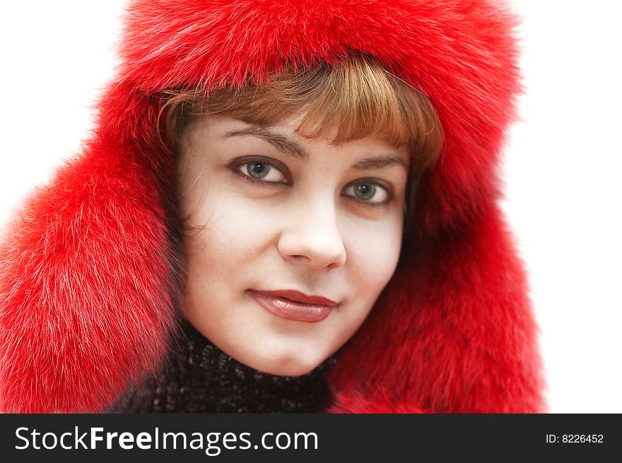 Young attractive woman in red fur-cap