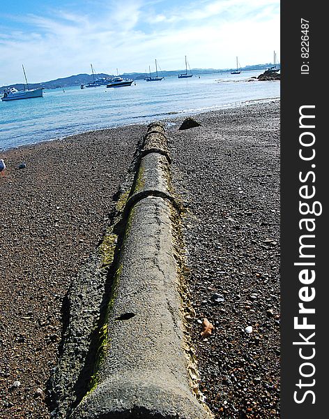 Sewer pipe at beach with many boats surrounded sea view