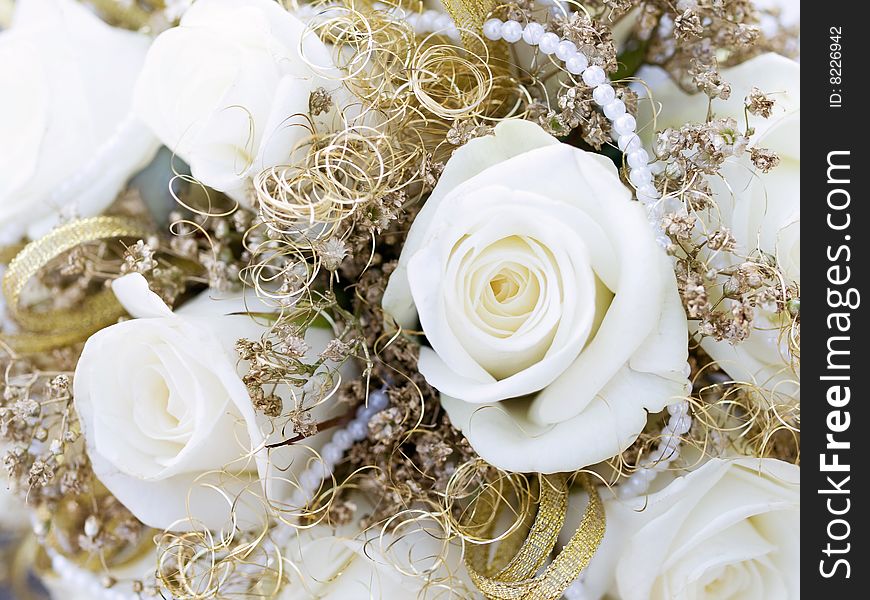 Close-up of roses and laces from wedding bouquet