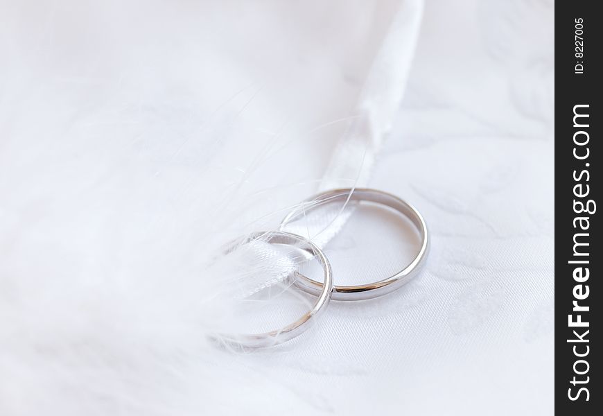 Closeup of wedding rings on a white textile