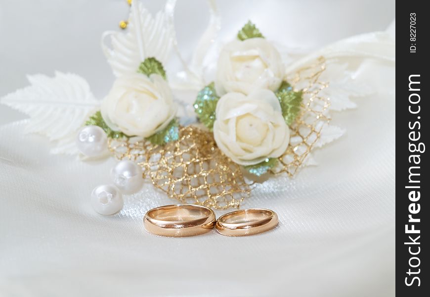 Closeup of wedding rings on a white textile