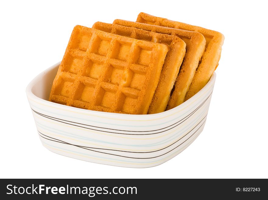 Four pieces of belgian waffles in plate isolated on white