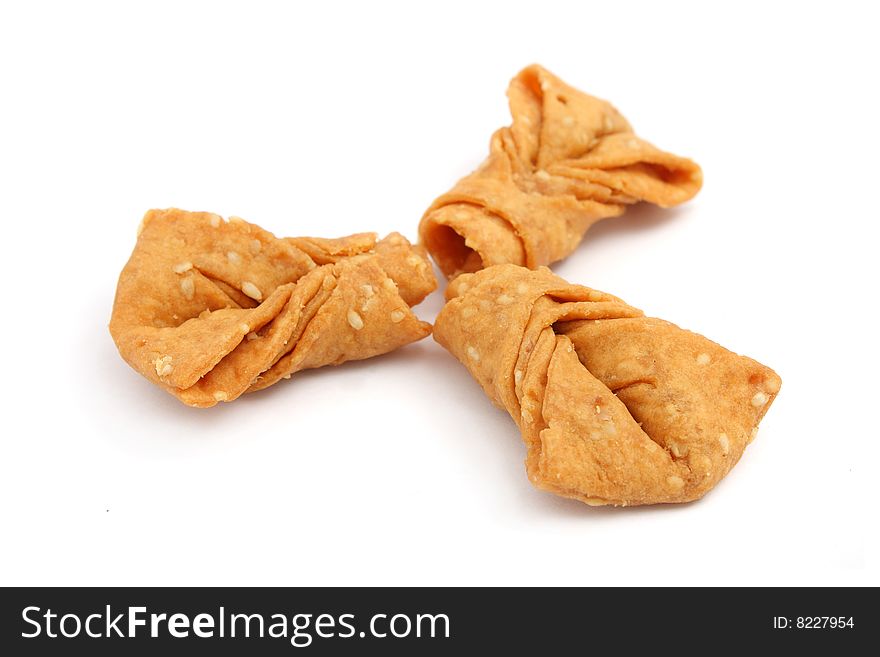 Sesame ribbon cookies isolated over white background.