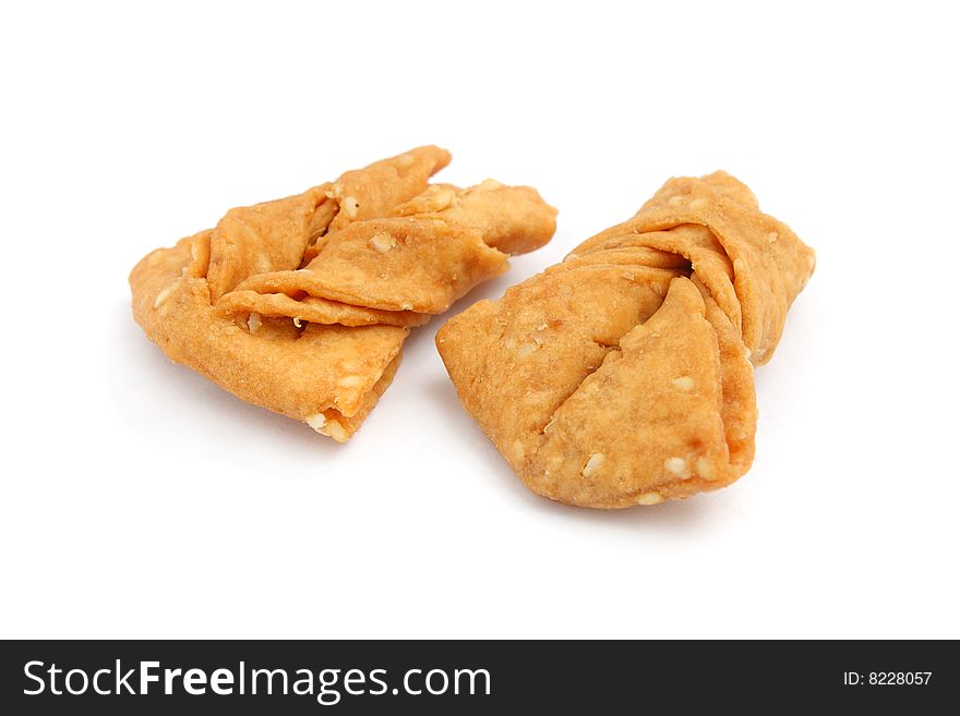 Sesame ribbon cookies isolated over white background.