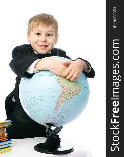 Happy little schoolboy smiling and embracing a big globe. Happy little schoolboy smiling and embracing a big globe