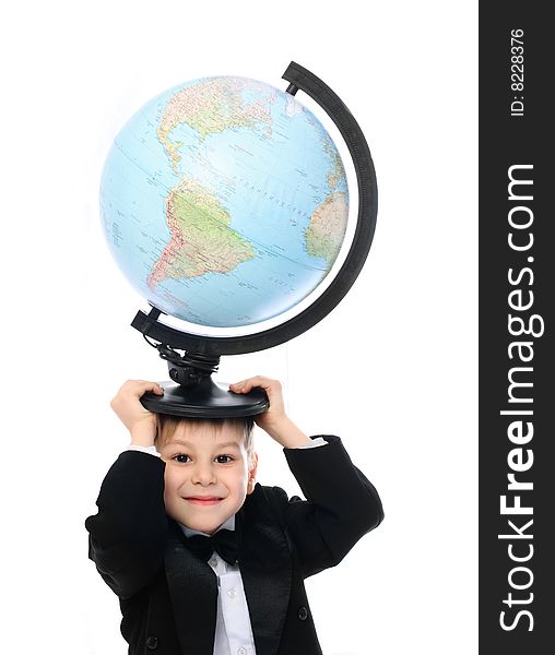 Happy little schoolboy holding a big globe on his head. Happy little schoolboy holding a big globe on his head