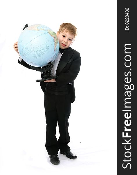 Portrait of a little schoolboy with a globe against white background