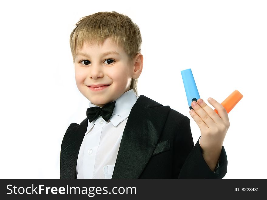 Happy little schoolboy with two felt-tip pens against white background