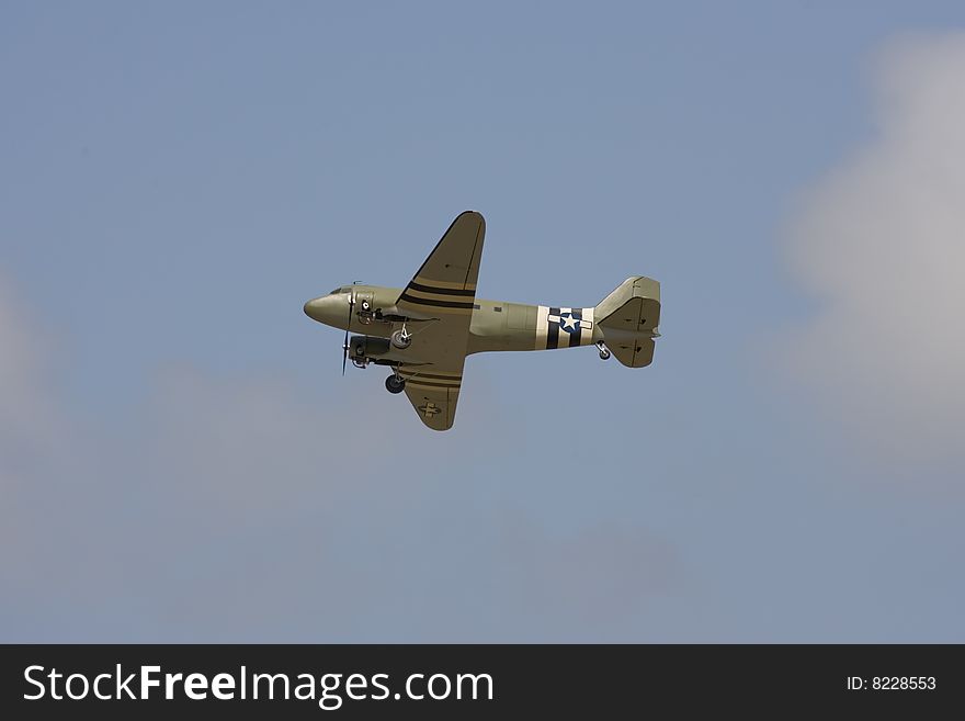An R/C model C-47 airplane doing a flyby for the crowd. An R/C model C-47 airplane doing a flyby for the crowd
