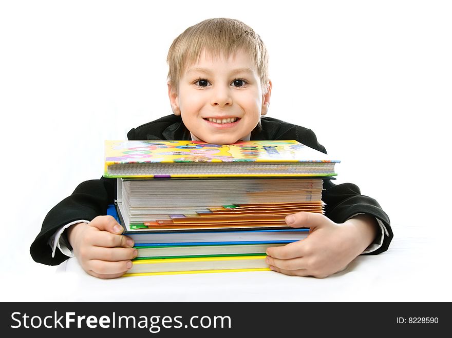 Happy schoolboy with books against white background