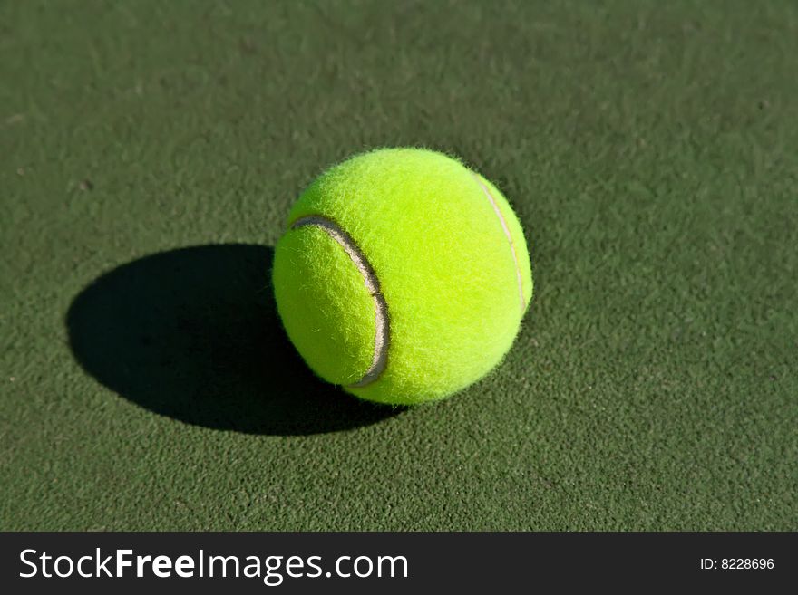 Yellow Tennis Ball on Hard Court